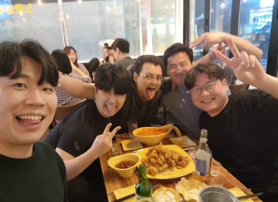 Bridge alumni Hunter posing with friends he made teaching in South Korea.
