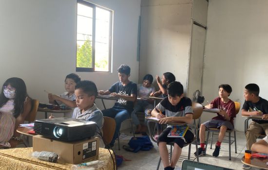 young students working on a fill-in-the-blanks story activity.