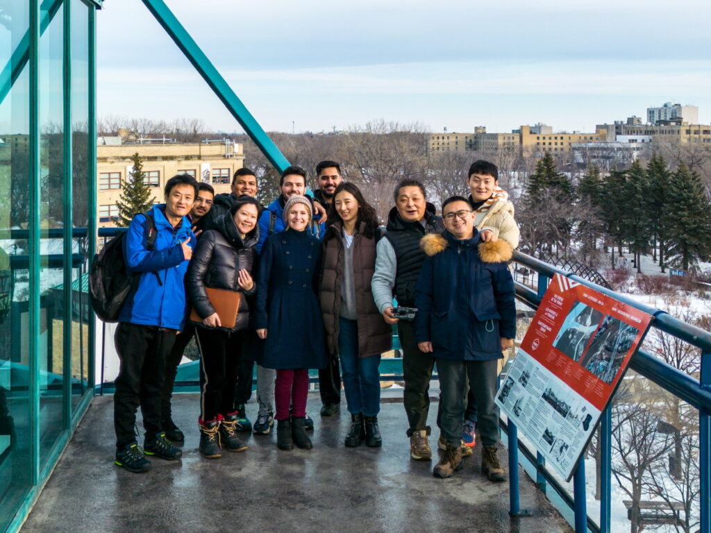 Jeannine and a group of her students standing on a balcony at the college in Winnipeg.