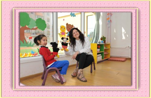 English teacher Andrea with a young student in a pink digital picture frame.