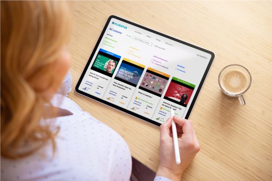 a woman choosing a lesson from Fluentize on her tablet