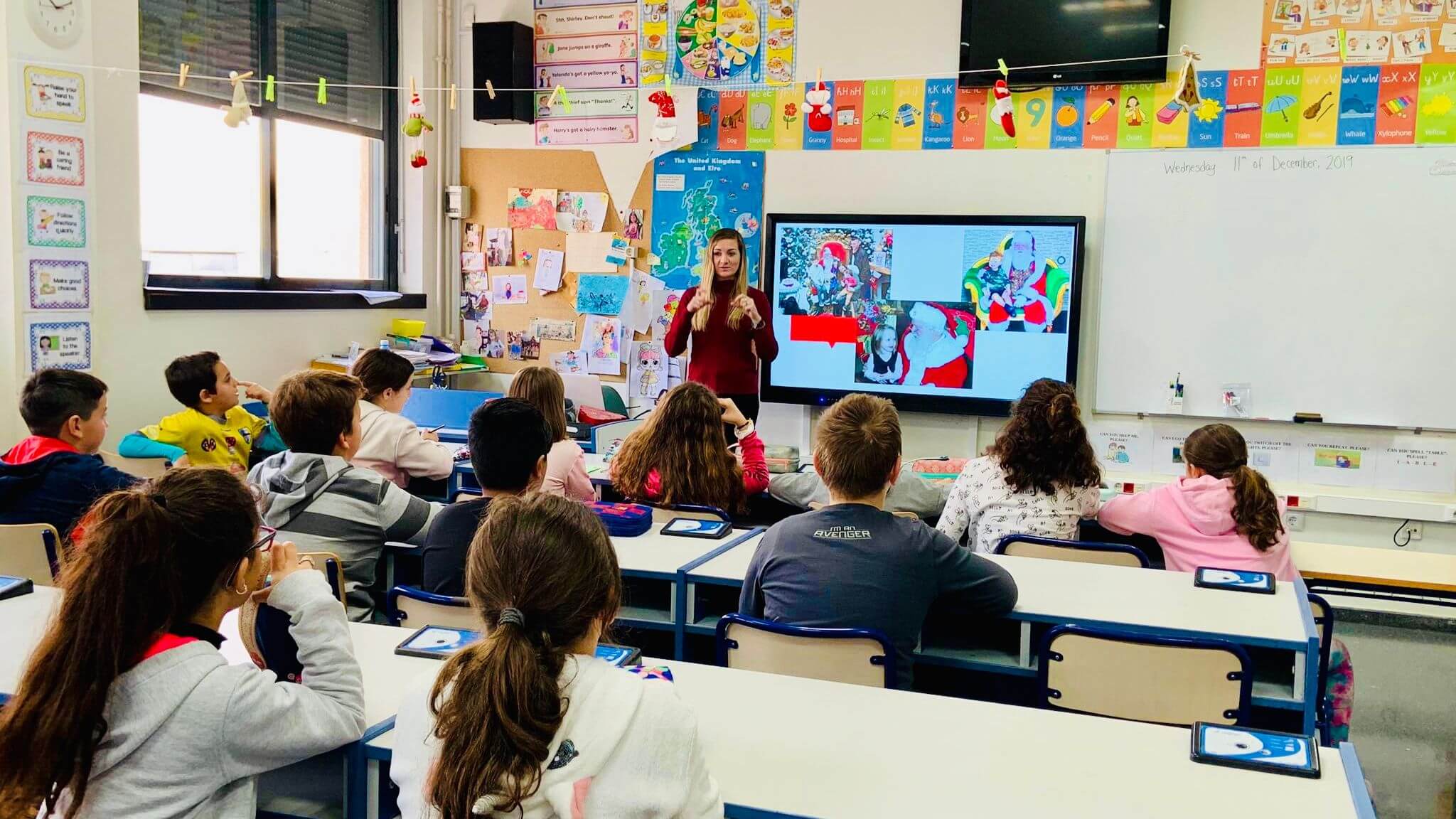 an RVF teacher teaching a classroom of young students.