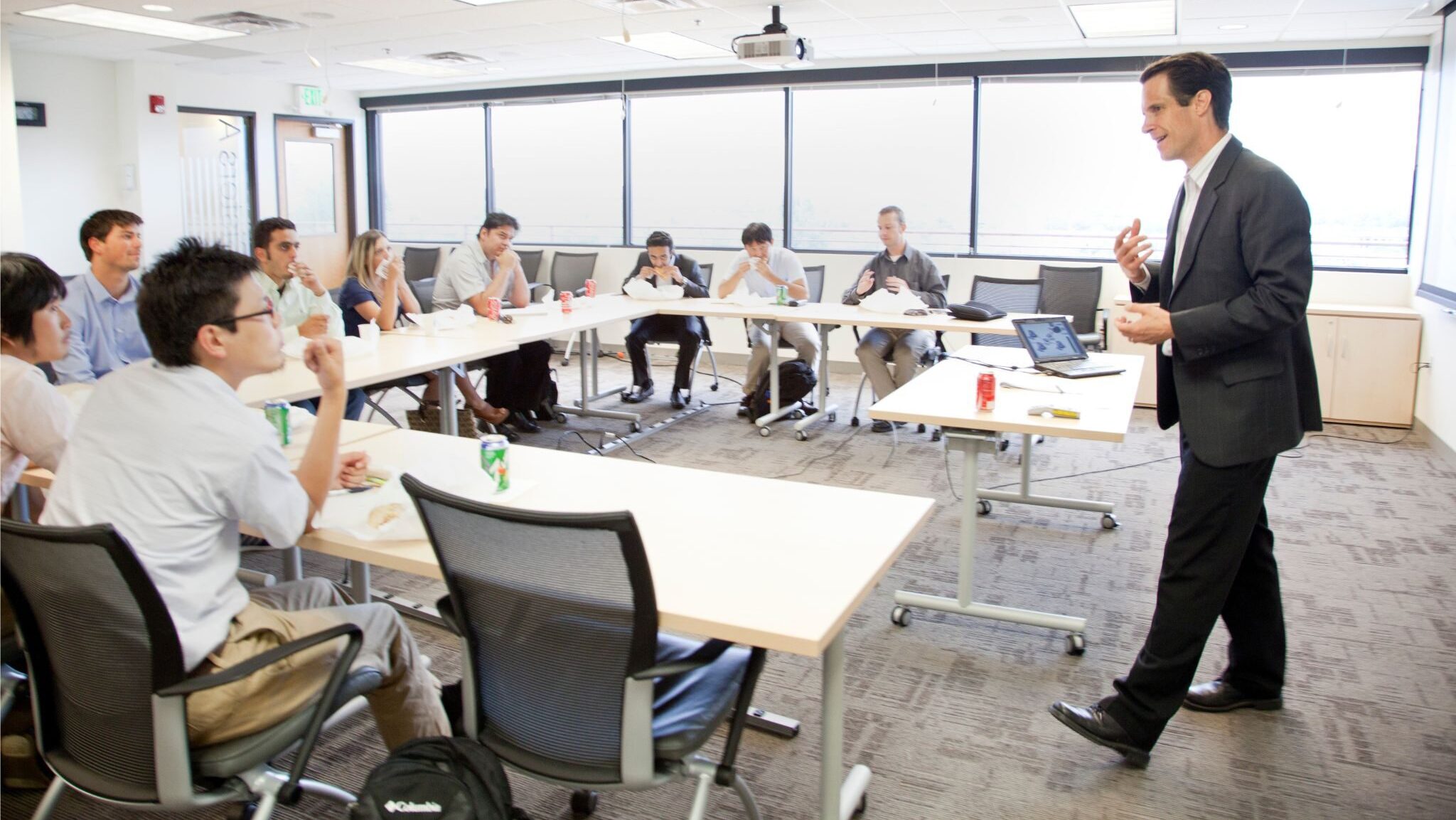a teacher leading a group business English class.