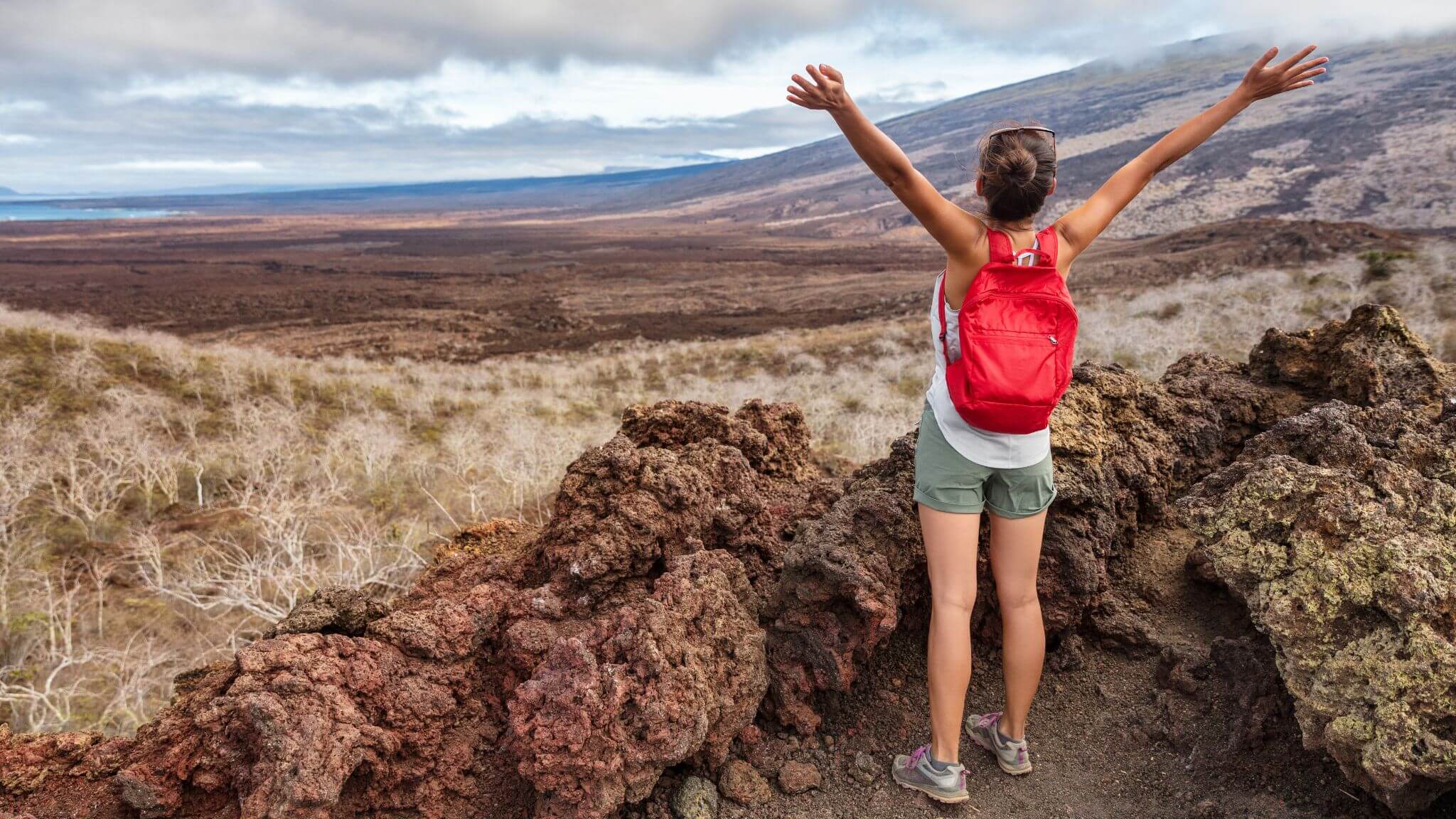 a woman hiking and stretching her arms