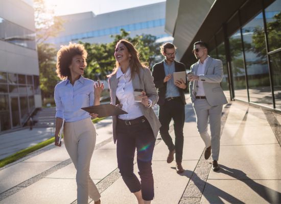 young professionals walking, talking, and laughing outside