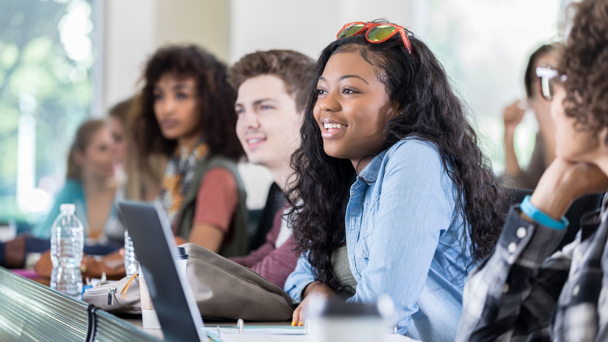 teen students in class with their laptops.
