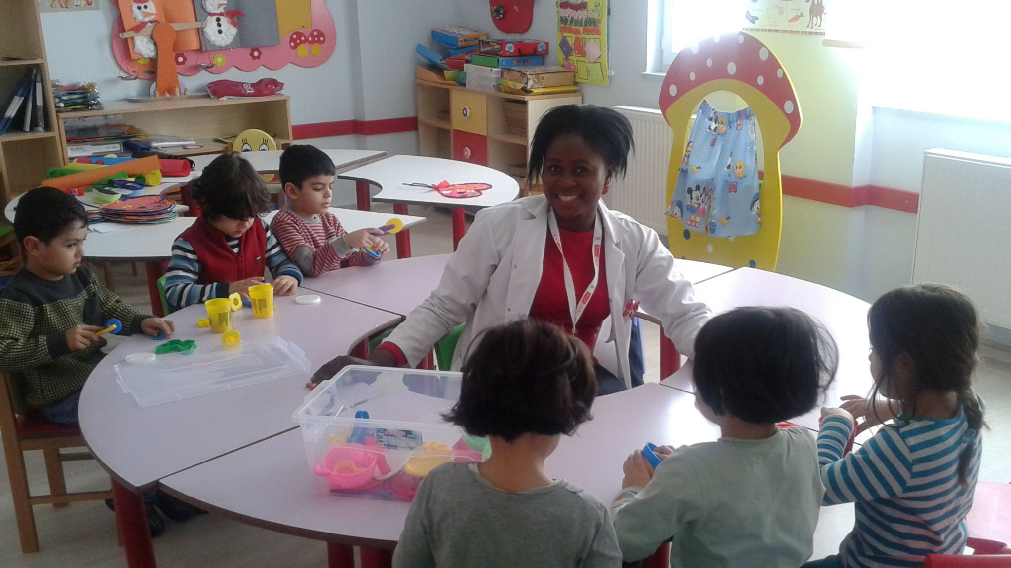 a teacher in a classroom teaching abroad with young children.