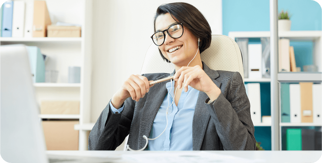 Business English and Specialized Courses A woman sitting with headphones having an online class
