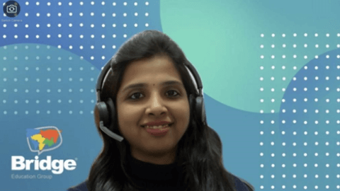 Teacher in online classroom smiling at camera