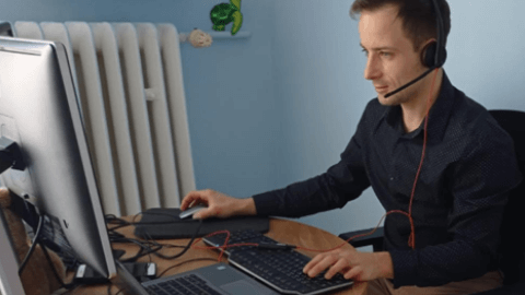 Teacher sitting at his desk in front of his computer