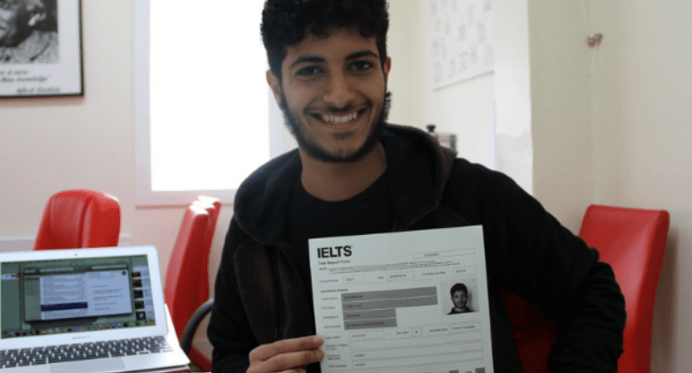A student poses with the results of his IELTS English language test.